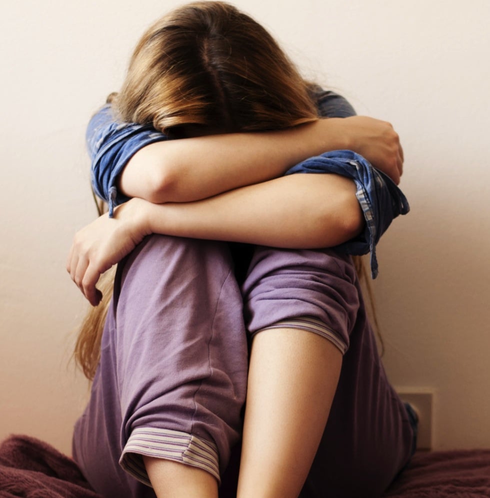 Woman hugging her knees