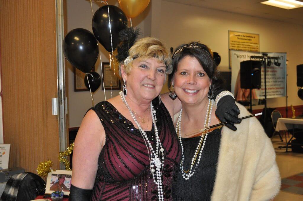 Women in 1920s costumes at event
