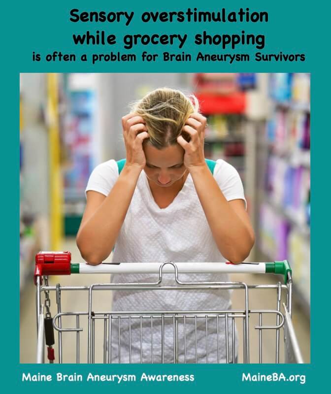 Woman with head in hands leaning over shopping cart