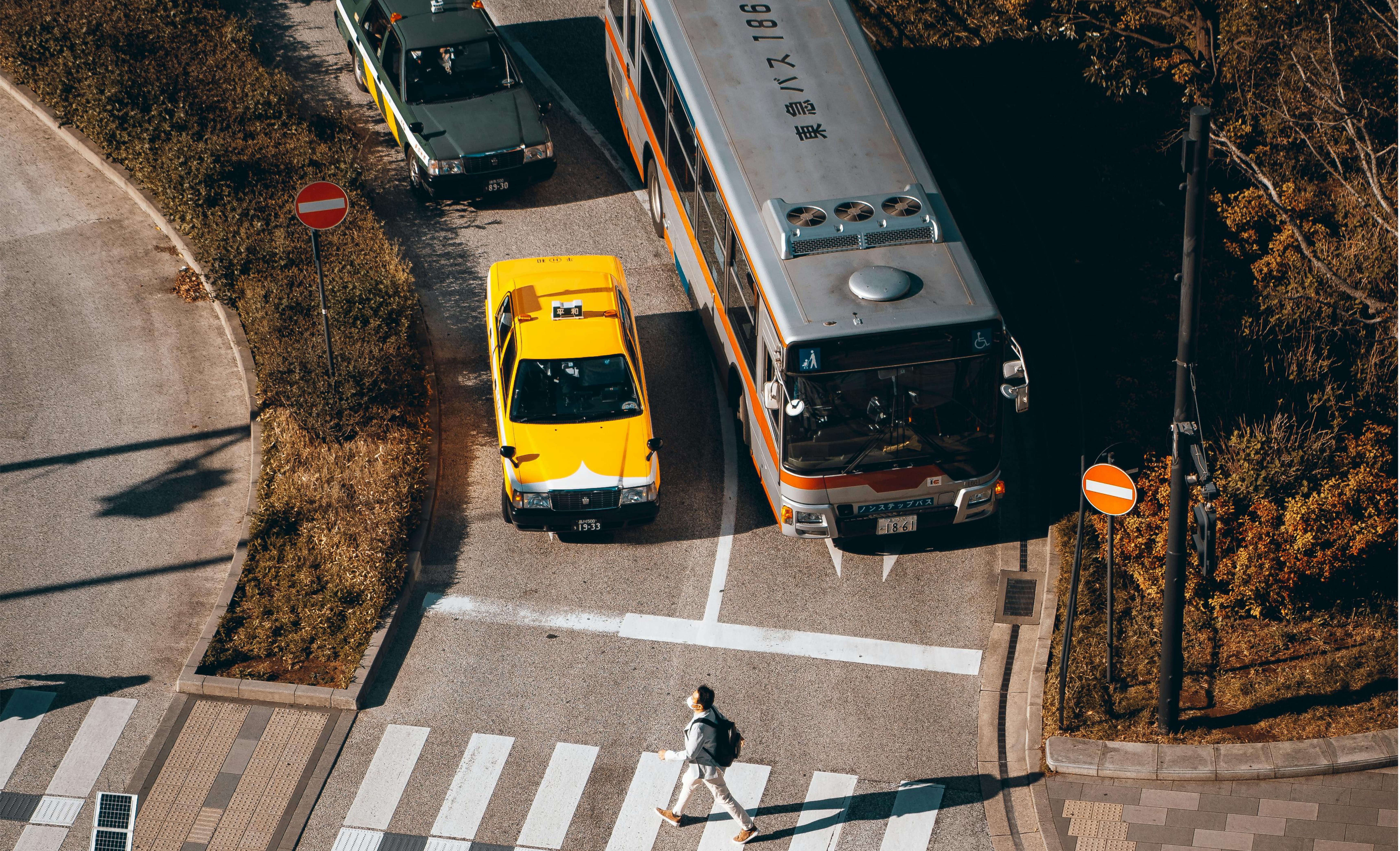 Taxi and Bus at an intersection
